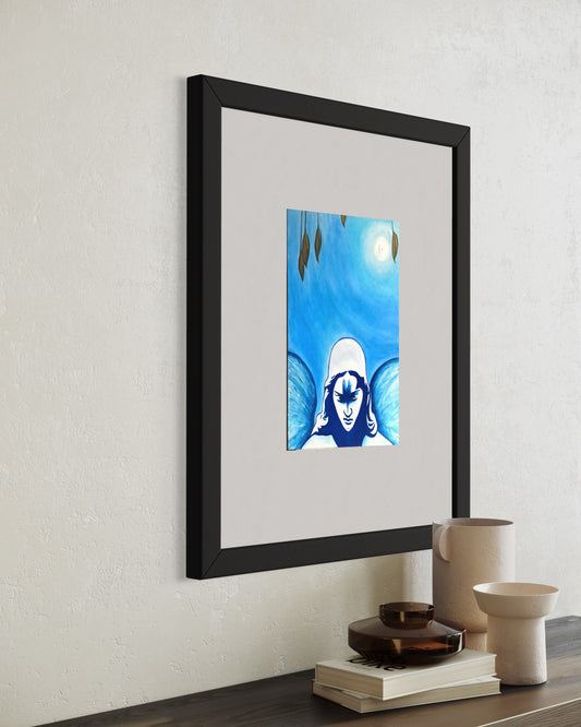 Framed artwork of a stylized face with blue background on a wall above a table.