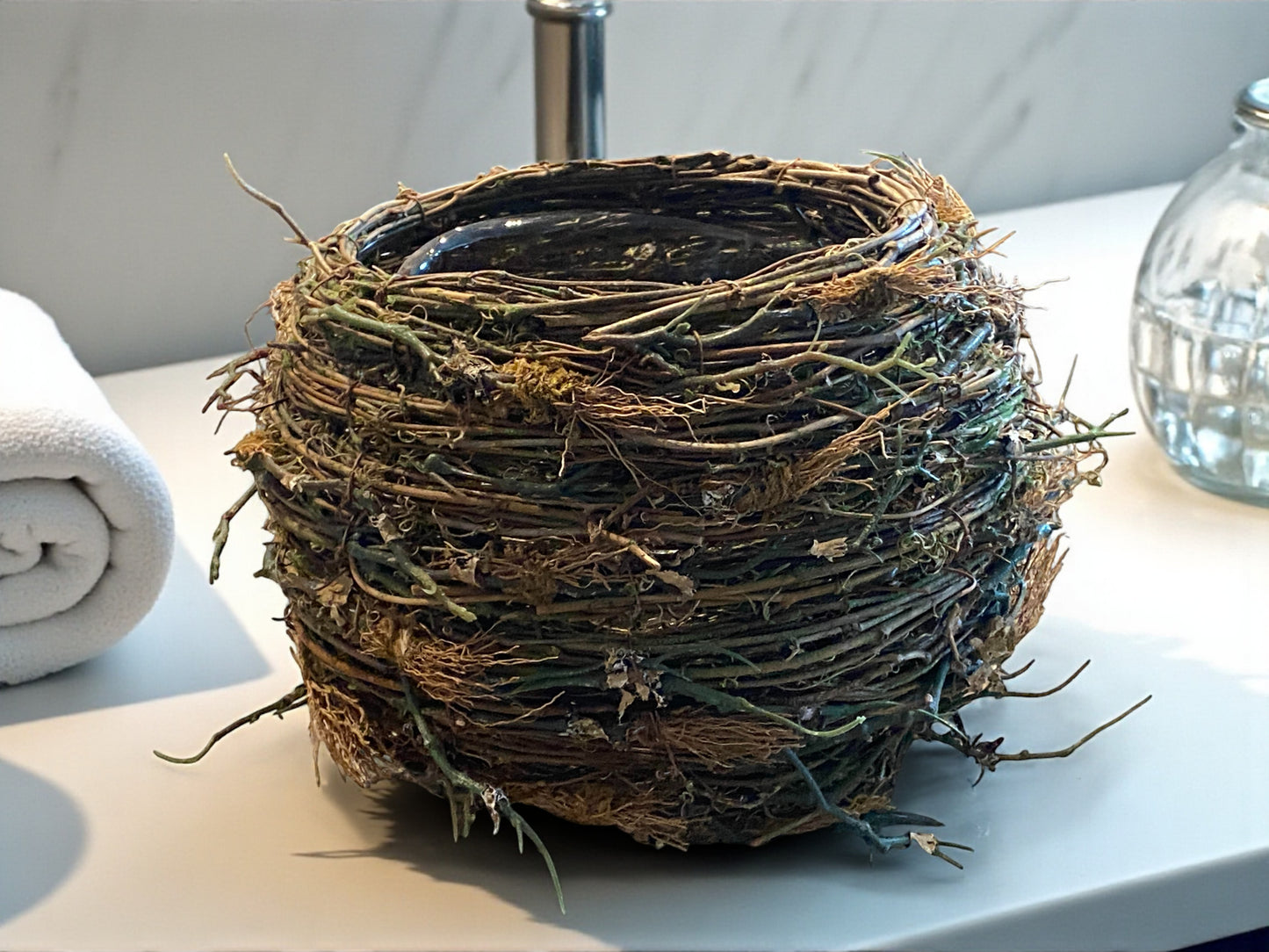 Artificial bird's nest on a surface with a neutral background