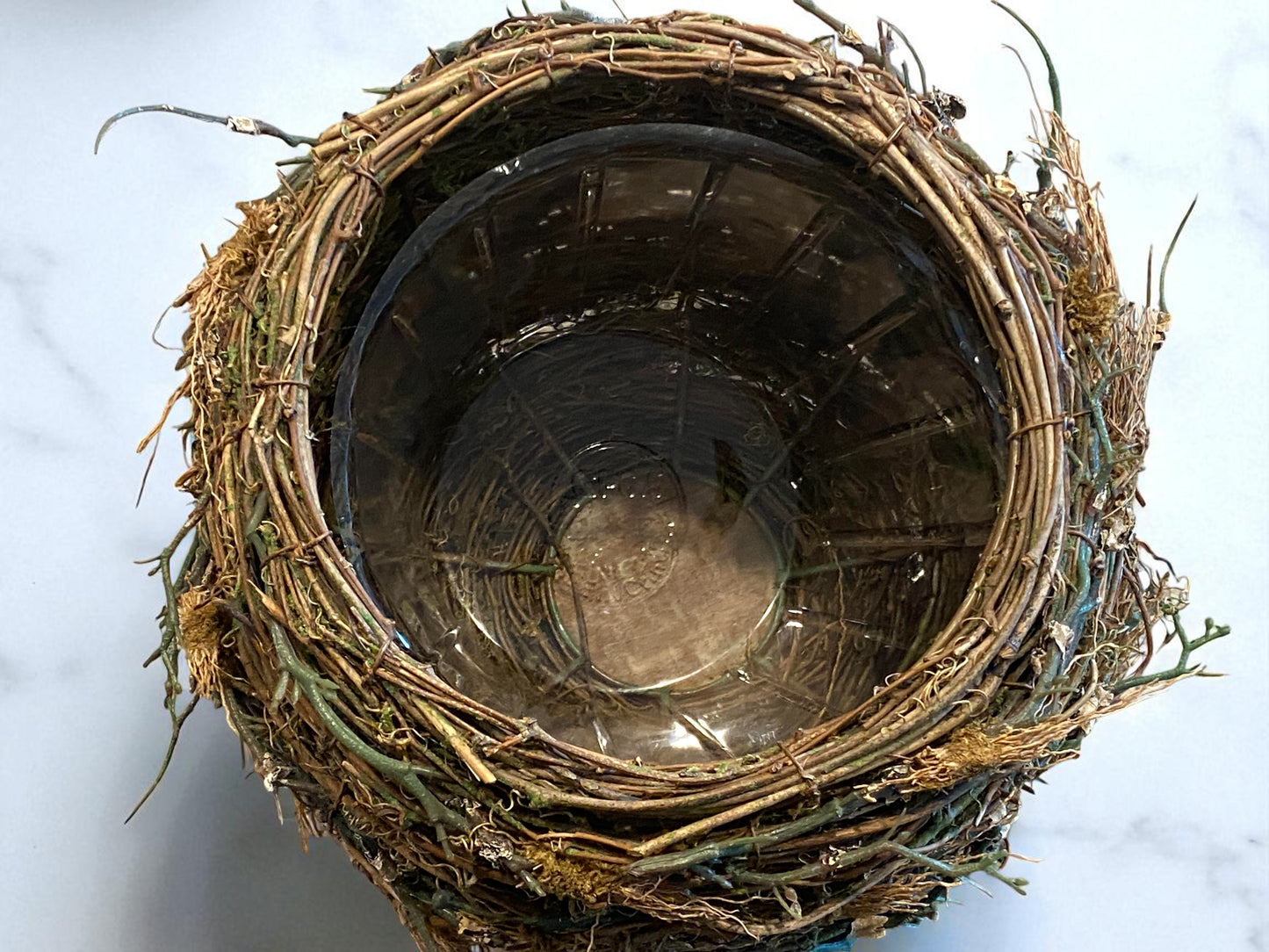 Close-up of organic twig and moss texture on bird’s nest planter
