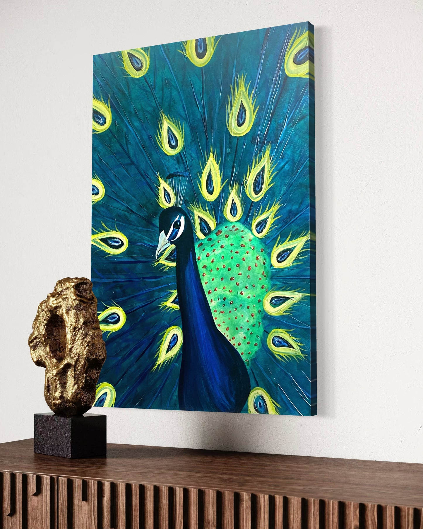 Canvas print of a peacock on a wall above a wooden cabinet with a decorative piece.