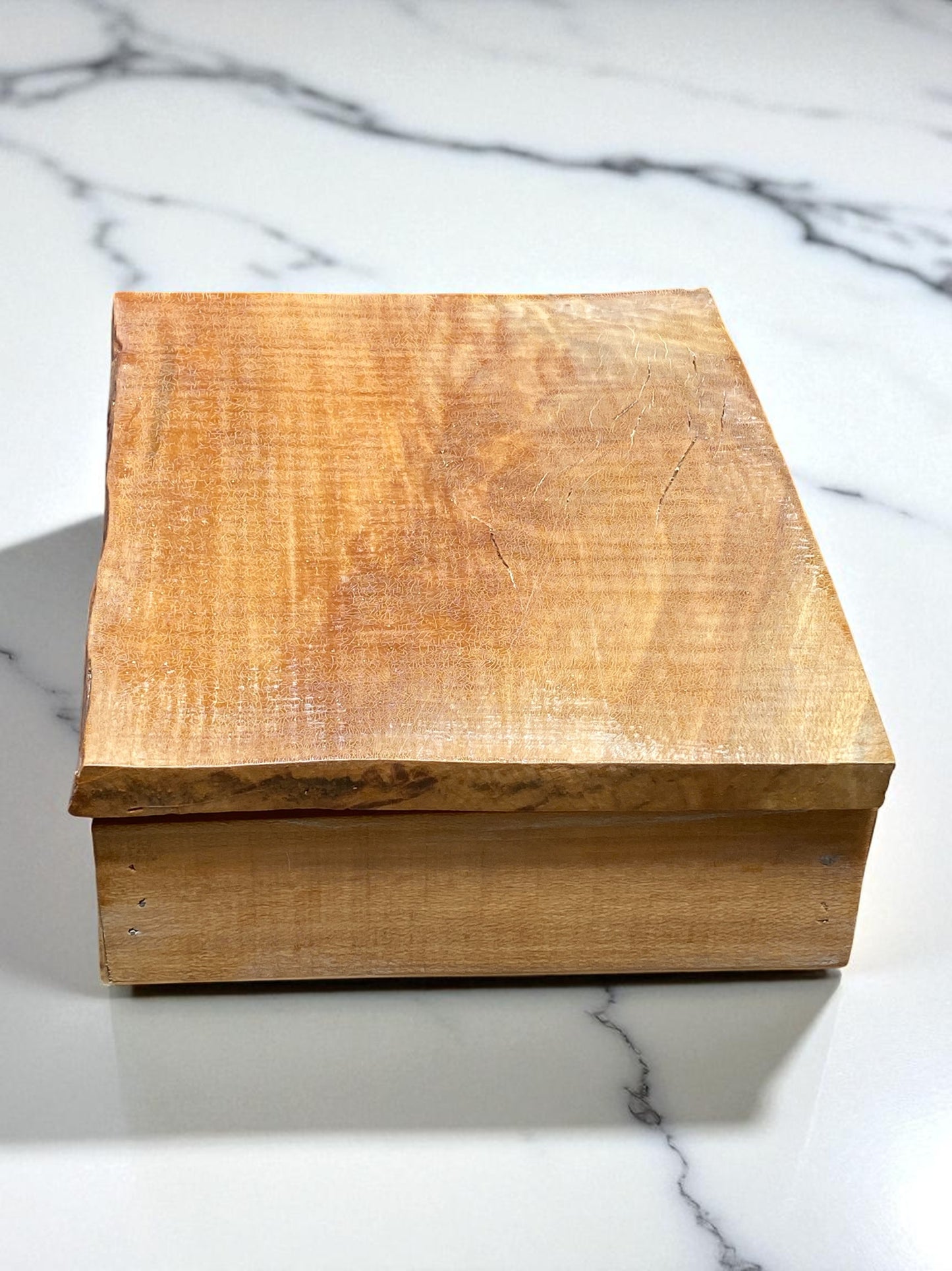 Wooden box on a marble surface