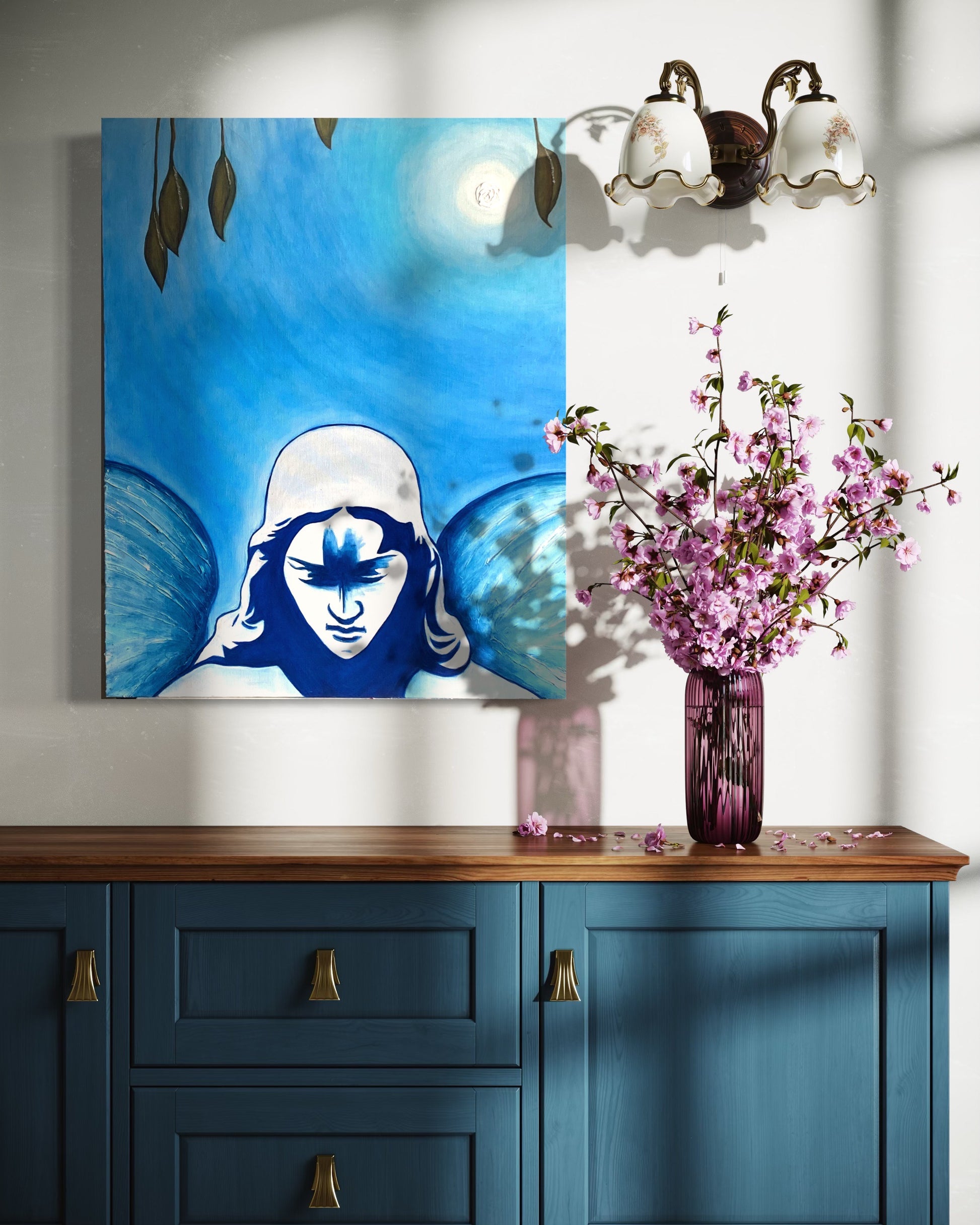 Blue cabinet with a painting of a face with blue hair, a purple vase with pink flowers, and a light fixture.
