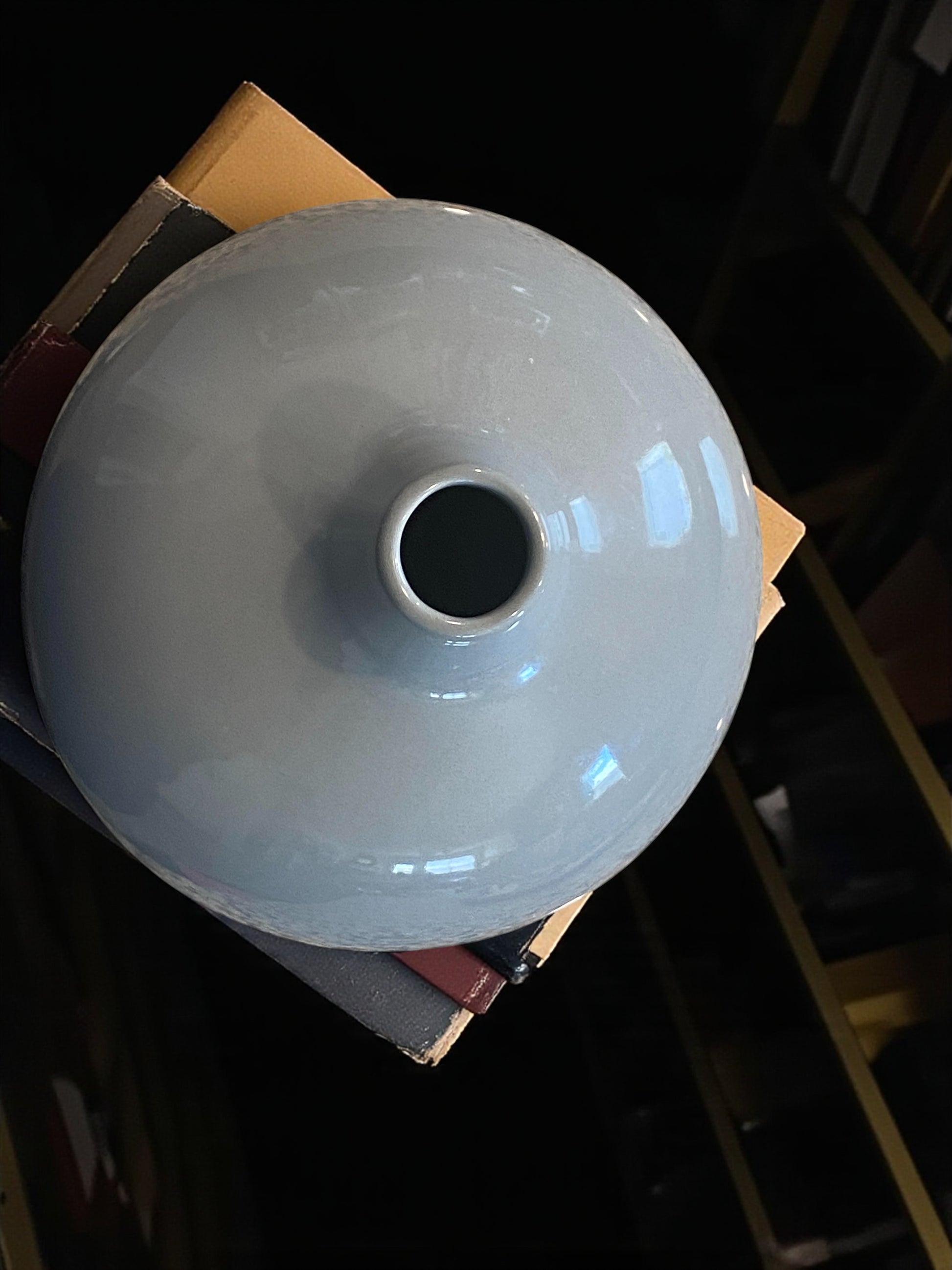 smoke blue ceramic vase on a dark surface