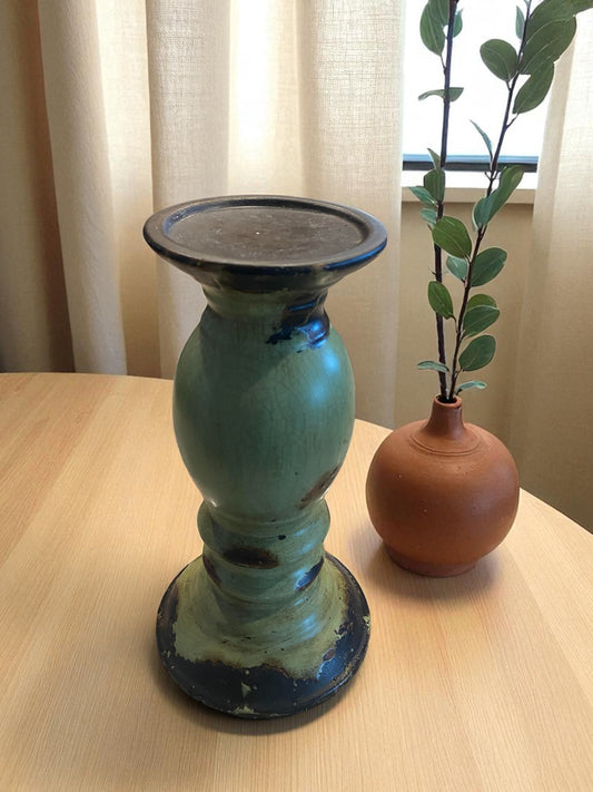 Two ceramic vases on a wooden surface with a neutral background
