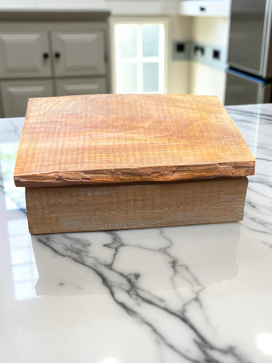 Wooden box on a marble countertop in a kitchen setting