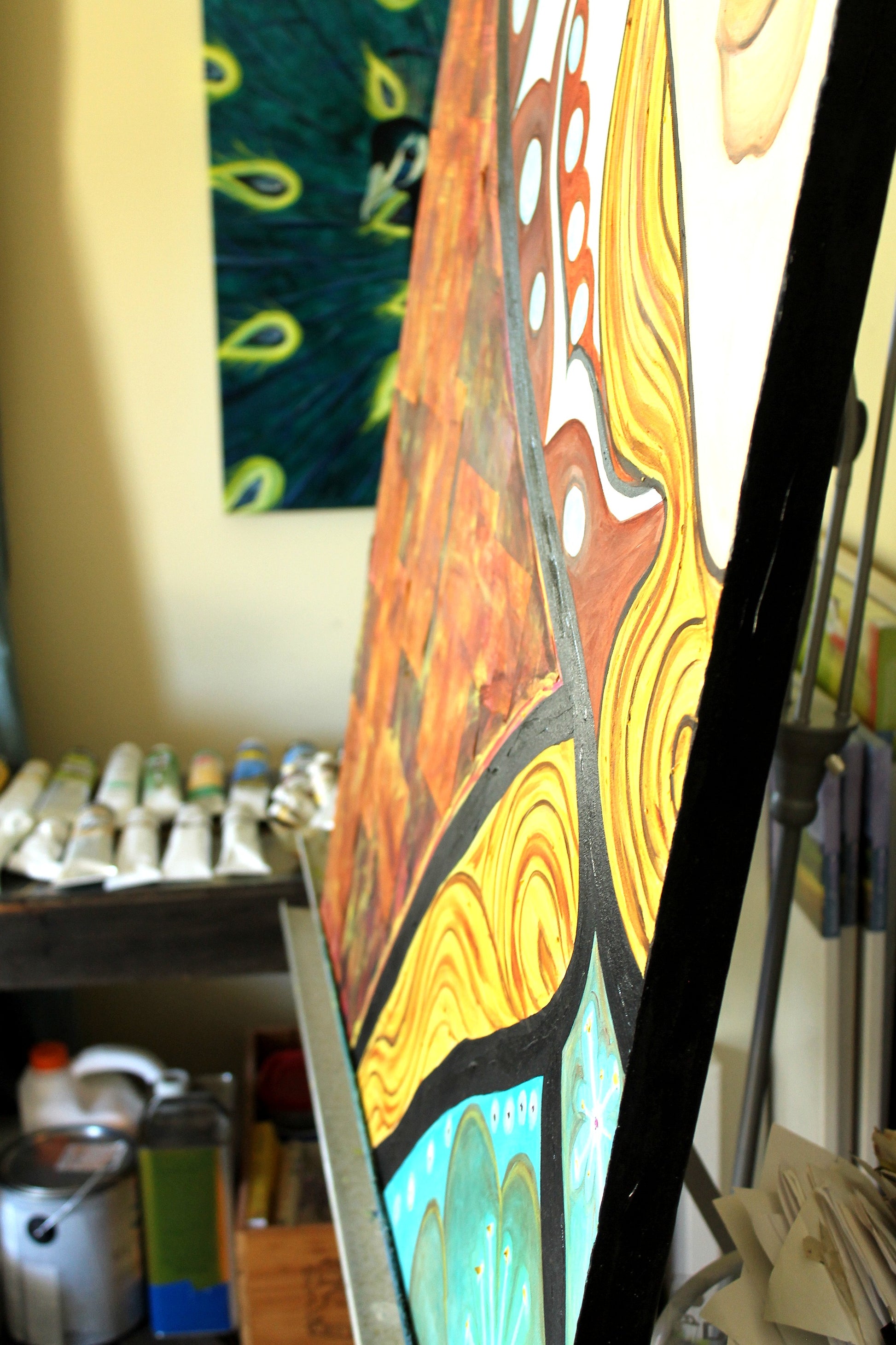 Artistic painting with abstract designs on a easel in an art studio.