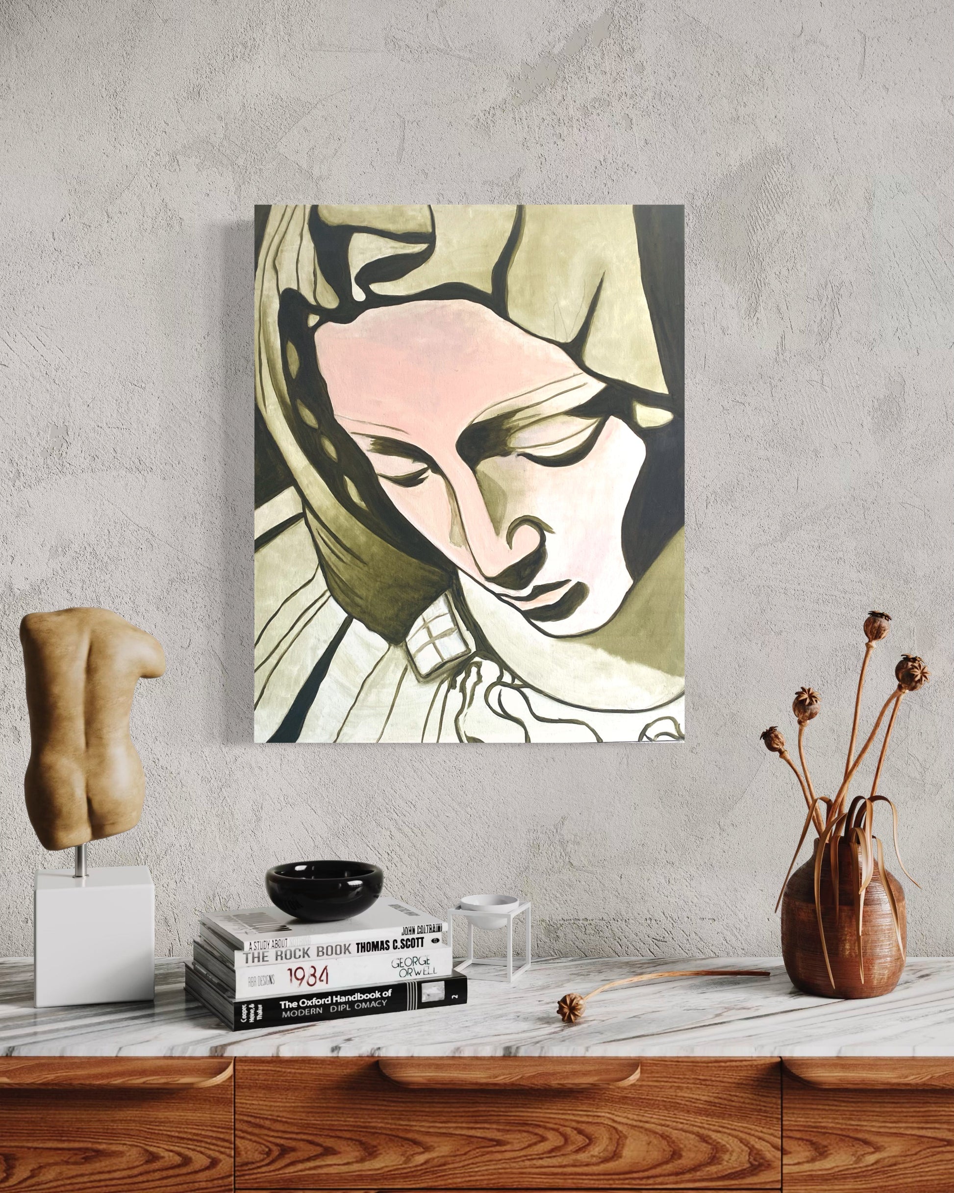 Artistic depiction of a woman's face on a wall above a wooden surface with decorative items.